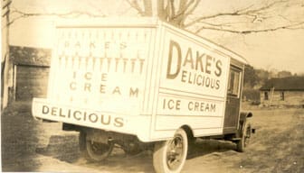 Bright red Model-T delivery truck with “Dake’s Delicious Ice Cream” on the side of it.