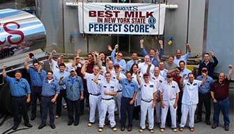 Stewarts employees raising their hands for the award