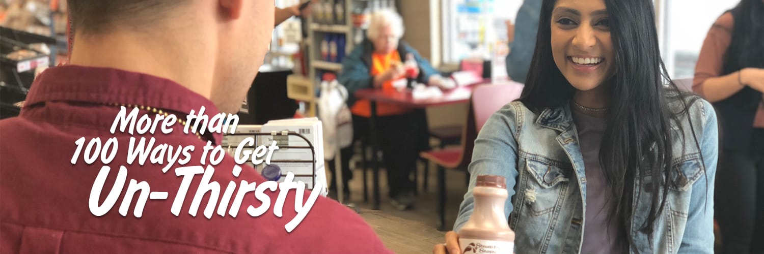 Girl buying a chocolate milk refresher from a Stewart's partner