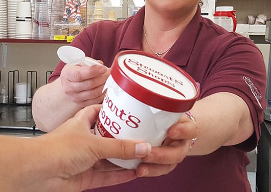 partner handing customer hand packed pint