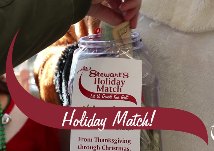 Holiday Match Donations jar with a hand placing in money. The text reads Holiday Match!