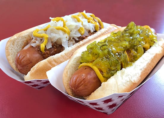 two hot dogs with toppings