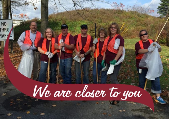 Stewart's employees wearing orange vests cleaning up garbage