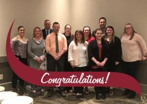 Group of Stewart's Partners at a luncheon. The word congratulations is written over them.