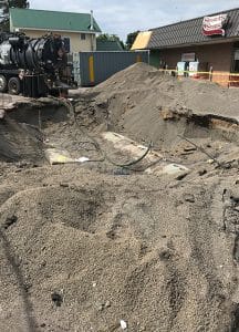 dirt piled around old gas tanks in the ground