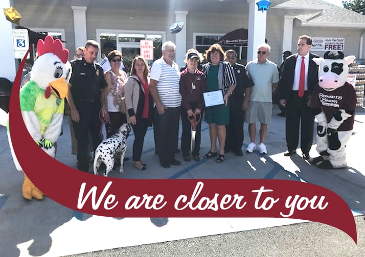 Crowd of people together outside of Stewart's Shop after ribbon cutting