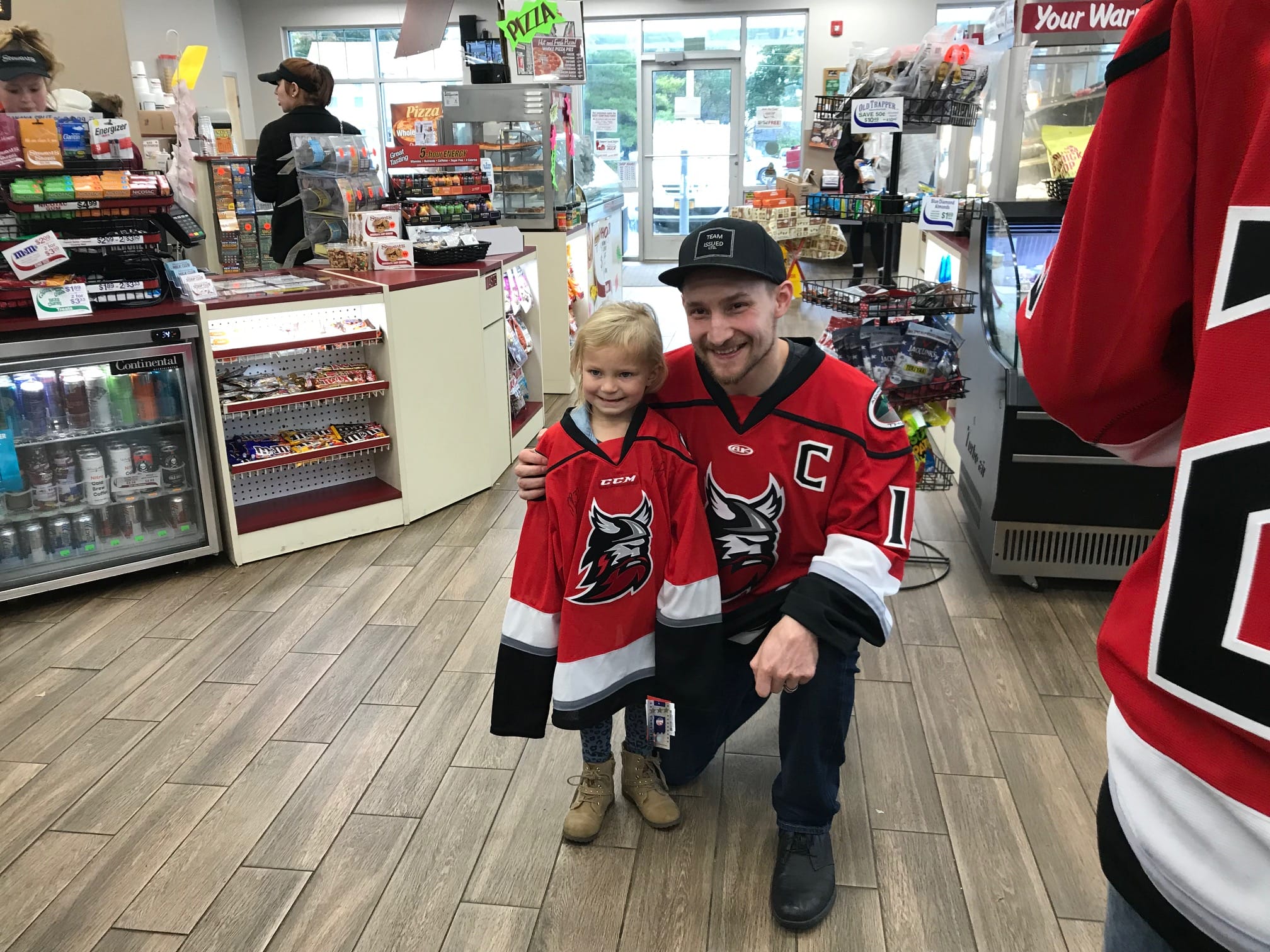 Hockey Player posing with Young fan