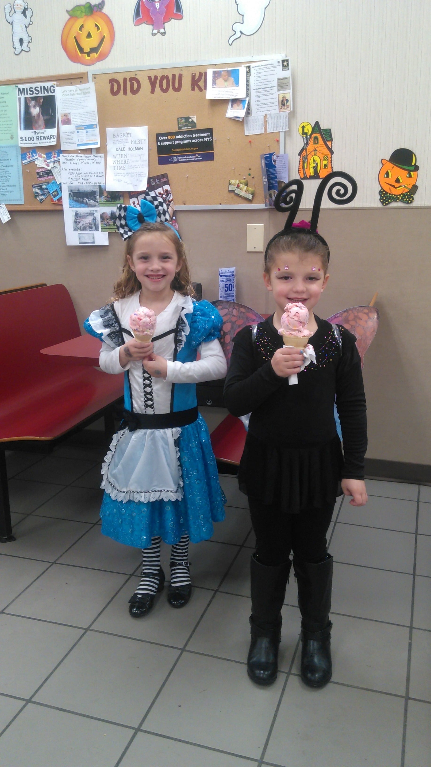 little girls enjoying ice cream on Halloween