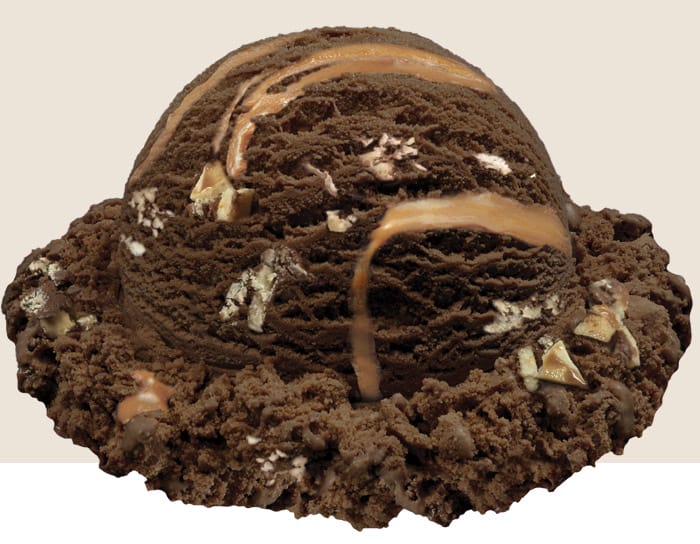 Large Image of the scoop of bark in the dark. Dark chocolate ice cream with a caramel swirl and pretzel bark pieces.