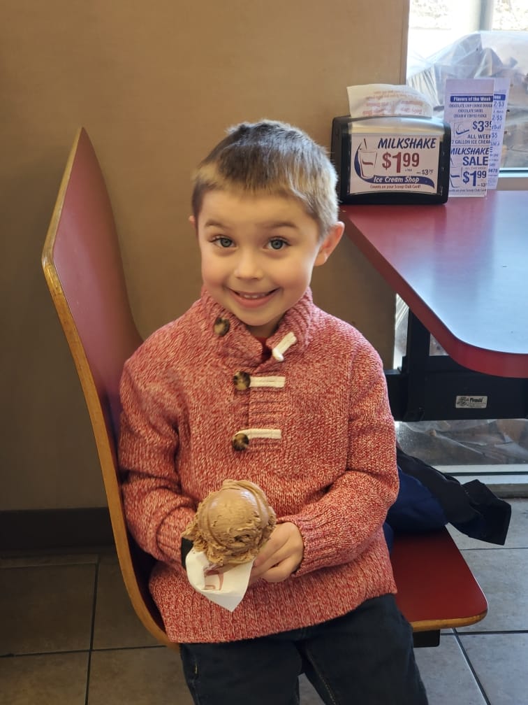 A young boy having an ice cream cone
