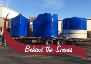 three tanks on a truck. Behind the scenes