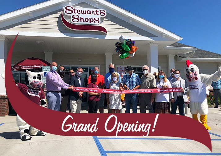 Group image of the ribbon cutting in front of the Port Henry shop. Grand Opening!