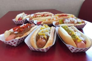 A variety of hot dogs with different toppings