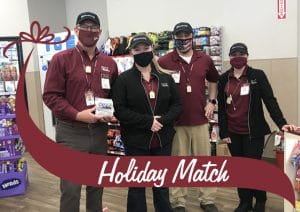 Holiday Match. Gary dake poses with employees
