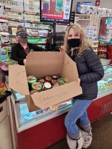 Teacher purchasing a box full of pints