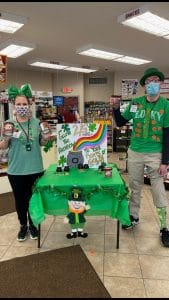 Shop Partners dressed for St. Patrick's Day, advertising the Pint Sale.