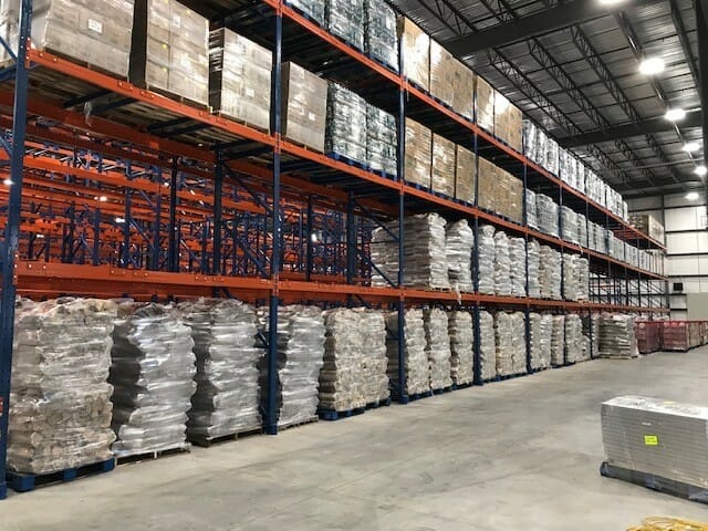 Steel racks inside the stewarts plant with firewood and other products