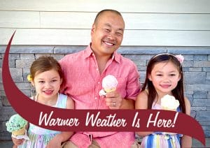 Family of 3 holding ice cream cones and smiling