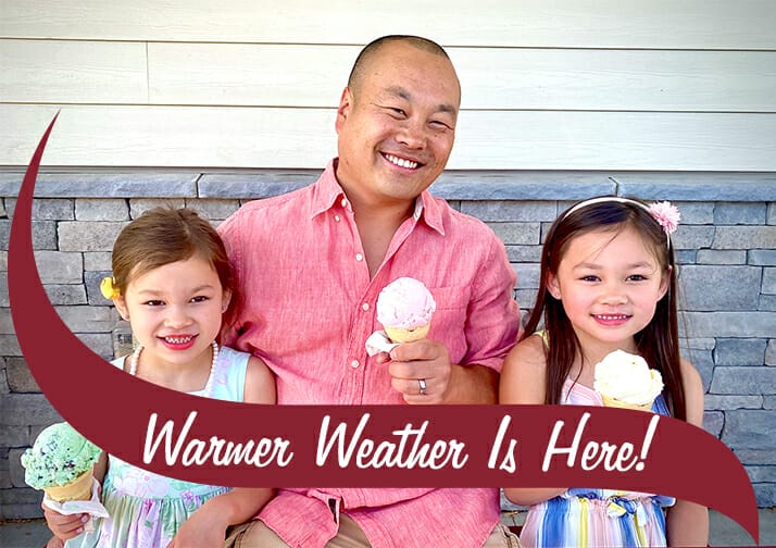 Family of 3 holding ice cream cones and smiling