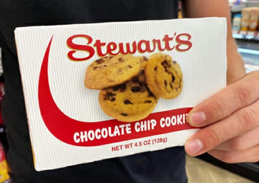 Customer holding box of mini chocolate chip cookies