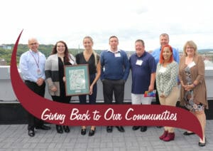 Partners standing with award