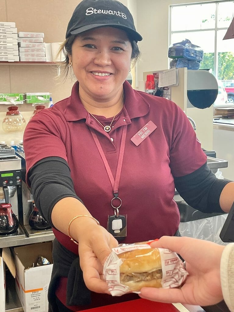 Partner Merri Serving customer a sandwich