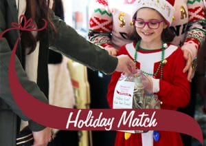 Little girl helping to collect funds for Holiday Match