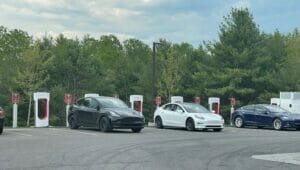 Tesla's charging at a Shop