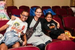 people sitting in theatre seats