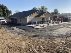 Ground view of a nearly completed shop. Construction happening to front. 