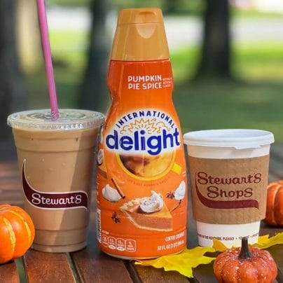 International Delight Pumpkin Pie Spice Creamer in the center. Iced coffee on the left. Hot coffee on the right. 