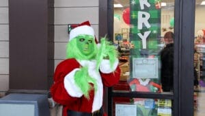 The Grinch in front of the shop. 