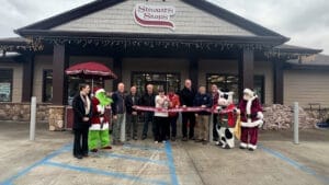 Ribbon cutting at Grand Opening in Lake Placid NY. Dignitaries, Shop Manager and Flavor the cow present. 
