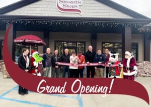 Ribbon cutting at Grand Opening in Lake Placid NY. Dignitaries, Shop Manager and Flavor the cow present.