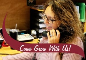 Wave reads "Come Grow with Us" with Angie, the bank manager, in the background at the Federal Credit Union.