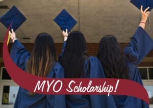 Three girls in blue graduation gowns holding caps in the air. There's a wave in front that reads MYO scholarship.