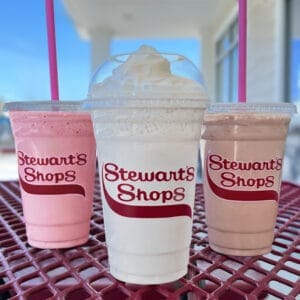 three milkshakes, chocolate, vanilla, strawberry. 