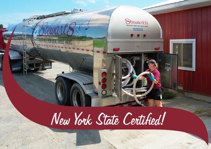 Dairy truck at a farm picking up milk. Wave in front that reads "NYS Grown & Certified"