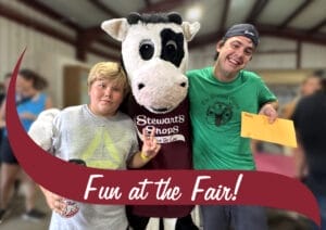 The winners of the 2025 Stewart's Shops ice cream pint eating contest pose with Stewart's mascot Flavor the cow.