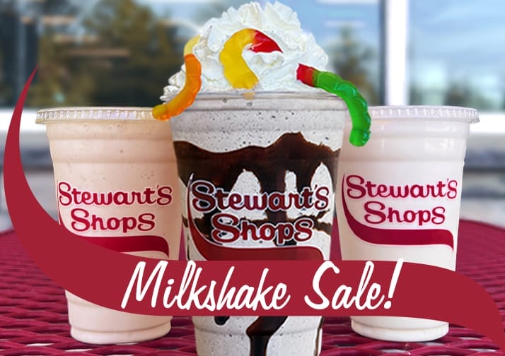 Three Stewart's milkshakes on a red table. Centered is the Dirt Cake milkshake with whipped cream and gummy worms. Red banner Milkshake Sale.